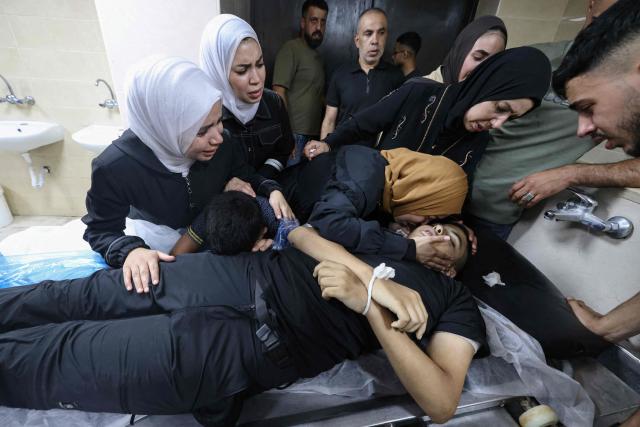 EDITORS NOTE: Graphic content / Relatives grieve over the body of Islam Ajouri, 14, at Rafidia Hospital in Nablus in the Israeli-occupied West Bank, on August 23, 2026, after he was allgedly killed earlier in the day by Israeli army gunfire at the nearby Askar refugee camp, according to the Palestinian health ministry. (Photo by JAAFAR ASHTIYEH / AFP)
