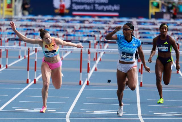 US' Alaysha Johnson (C) competes to win followed by third placed Poland's Pia Skrzyszowska (L) and last placed US' Kendra Harrison (R) in the women's 100mt hudles competition of the Silesia Diamond League athletics meeting in Katowice, Poland, on August 23, 2026. (Photo by Wojtek RADWANSKI / AFP)