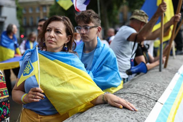 Participants display Ukraine flags during a rally outside Downing Street in central London on August 23, 2026, to mark Ukraine's 35th anniversary of independence on August 24. (Photo by Toby Shepheard / AFP)