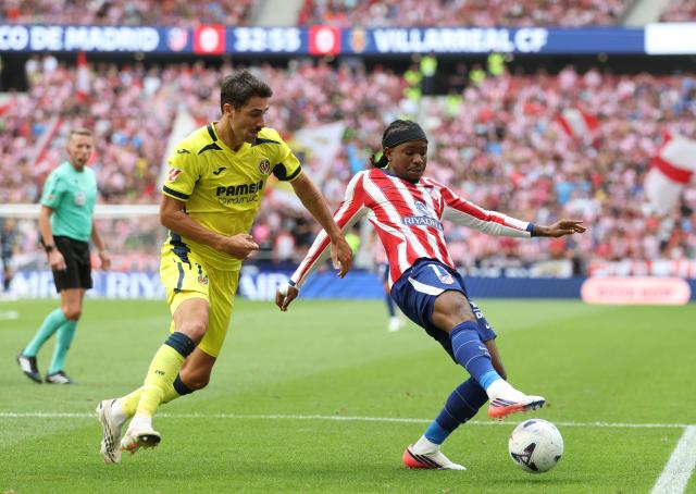 Villarreal's Spanish midfielder #14 Santi Comesana fights for the ball with Atletico Madrid's Nigerian forward #11 Ademola Lookman during the Spanish league football match between Club Atletico de Madrid and Villarreal CF at Metropolitano Stadium in Madrid on August 23, 2026. (Photo by Pierre-Philippe MARCOU / AFP)