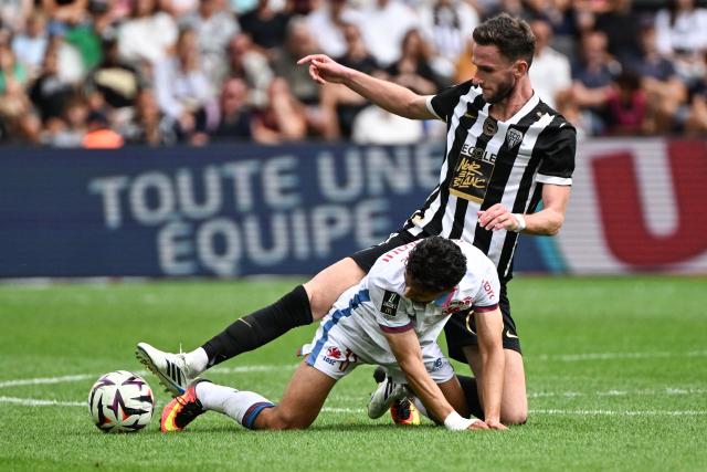 Angers' Dutch midfielder #8 Branco Van den Boomen (down) fights for the ball with Lille’s Norwegian forward #11 Osame Sahraoui (up) during the French L1 football match between Angers SCO and LOSC Lille at the Stade Raymond Kopa in Angers, western France on August 23, 2026. (Photo by Sebastien Salom-Gomis / AFP)