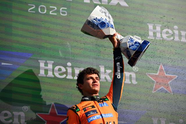 P1 McLaren's British driver Lando Norris celebrates with the trophy on the podium after the Formula One Dutch Grand Prix at The Circuit Zandvoort, western Netherlands, on August 23, 2026. (Photo by JOHN THYS / AFP)
