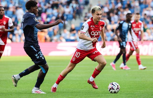 Monaco's Russian midfielder #10 Aleksandr Golovin (R) controls the ball past Le Havre's French defender #32 Timothee Pembele (L) during the French L1 football match between Le Havre AC and AS Monaco at the Stade Oceane in Le Havre, northwestern France on August 23, 2026. (Photo by Fred TANNEAU / AFP)