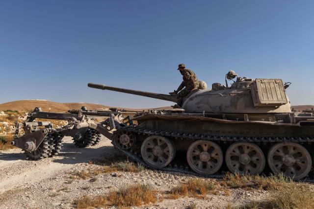 A Syrian army soldier sits on a mine-clearing tank of the Syrian Ministry of Defence's military engineering department during a demining operation in Qarah in the Damascus countryside on August 23, 2026. (Photo by Bakr ALkasem / AFP)