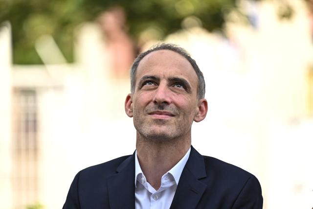 (FILES) Place publique's centre-left party leader and MEP Raphael Glucksmann looks on following a visit to a school, in Artigues-pres-Bordeaux, outside Bordeaux, southwestern France on June 26, 2026. Commentator-turned-politician Raphael Glucksmann on April 23, 2026, announced his candidacy for France's presidential election next year, joining a crowded field of far-right figures, centrists and fellow left-wingers. (Photo by Christophe ARCHAMBAULT / AFP) / The erroneous mention[s] appearing in the metadata of this photo by Christophe ARCHAMBAULT has been modified in AFP systems in the following manner: [following a visit to a school] instead of [during a visit to the Envie 2E Aquitaine professional insertion company]. Please immediately remove the erroneous mention[s] from all your online services and delete it (them) from your servers. If you have been authorized by AFP to distribute it (them) to third parties, please ensure that the same actions are carried out by them. Failure to promptly comply with these instructions will entail liability on your part for any continued or post notification usage. Therefore we thank you very much for all your attention and prompt action. We are sorry for the inconvenience this notification may cause and remain at your disposal for any further information you may require.