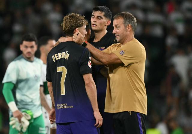 Barcelona's German coach Hans-Dieter Flick hugs Barcelona's Spanish midfielder #07 Fermin Lopez at the end of the Spanish league football match between Elche CF and FC Barcelona at Martinez Valero Stadium in Elche on August 23, 2026. (Photo by JOSE JORDAN / AFP)