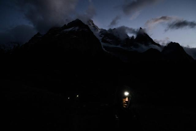 (FILES) A trailer competes in the 22nd edition of the Ultra Trail du Mont Blanc (UTMB), a 174km trail race crossing France, Italy and Switzerland in Chamonix, south-eastern France on August 30, 2025. In Chamonix, the UTMB — which 23rd edition begins on August 24, 2026 — divides locals: some cherish it, while others complain the town is overwhelmed, with traffic jams and crowds making daily life difficult for a week. The event brings together more than 10,000 runners across eight races, including Friday's flagship event — a 174 km loop with 9,900 m of elevation gain around Mont Blanc — which will field 2,500 participants, up from just 300 entrants in the single race held at the first edition in 2003. (Photo by JEFF PACHOUD / AFP)