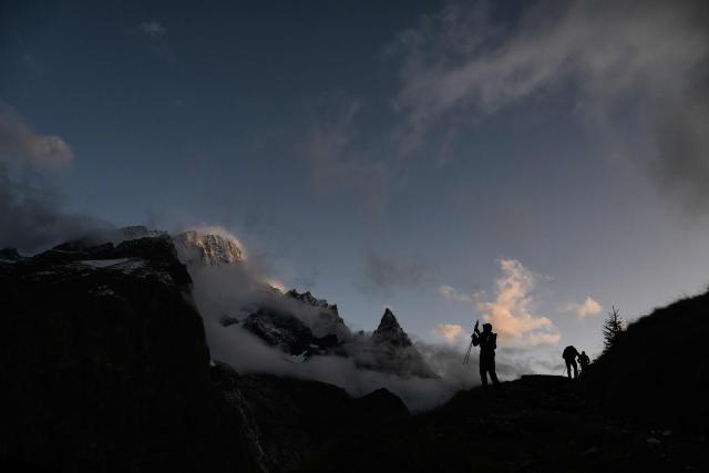 (FILES) Trailers compete in the 22nd edition of the Ultra Trail du Mont Blanc (UTMB), a 174km trail race crossing France, Italy and Switzerland in Chamonix, south-eastern France on August 30, 2025. In Chamonix, the UTMB — which 23rd edition begins on August 24, 2026 — divides locals: some cherish it, while others complain the town is overwhelmed, with traffic jams and crowds making daily life difficult for a week. The event brings together more than 10,000 runners across eight races, including Friday's flagship event — a 174 km loop with 9,900 m of elevation gain around Mont Blanc — which will field 2,500 participants, up from just 300 entrants in the single race held at the first edition in 2003. (Photo by JEFF PACHOUD / AFP)