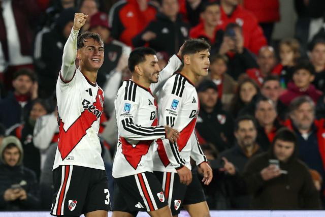 River Plate's forward #35 Joaquin Freitas celebrates next to teammates after an own goal scored by Velez Sarsfield's defender #32 Thiago Silvero (out of frame) during the Argentine Professional League 2026 Clausura football match between River Plate and Velez Sarsfield at MAS Monumental Stadium in Buenos Aires on August 23, 2026. (Photo by Alejandro PAGNI / AFP)