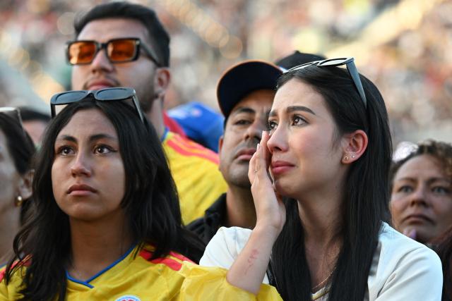 Attendees react during the "Voces por la Vida" charity concert to support people affected by the 7.4-magnitude earthquake at the Vive Claro Distrito Cultural music venue in Bogota on August 23, 2026. (Photo by Raul ARBOLEDA / AFP)