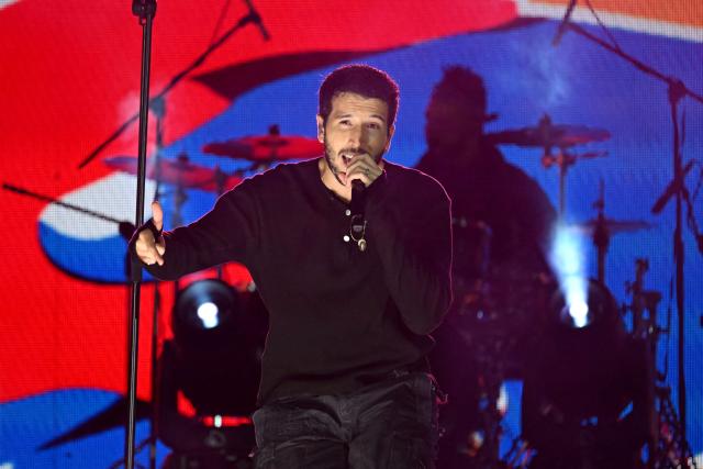 Colombian singer Sebastian Yatra performs on stage during the "Voces por la Vida" charity concert to support people affected by the 7.4-magnitude earthquake at the Vive Claro Distrito Cultural music venue in Bogota on August 23, 2026. (Photo by Raul ARBOLEDA / AFP)