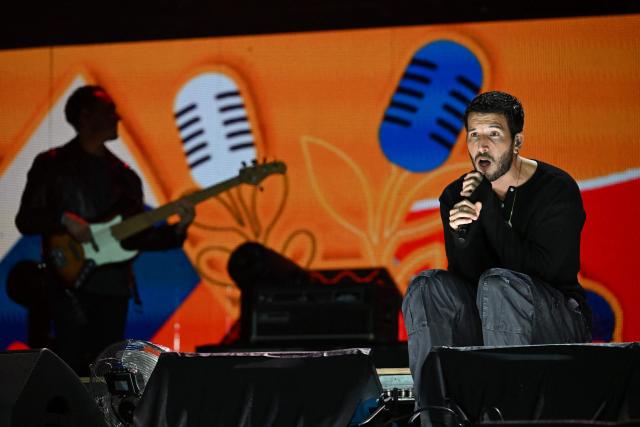 Colombian singer Sebastian Yatra performs on stage during the "Voces por la Vida" charity concert to support people affected by the 7.4-magnitude earthquake at the Vive Claro Distrito Cultural music venue in Bogota on August 23, 2026. (Photo by Raul ARBOLEDA / AFP)