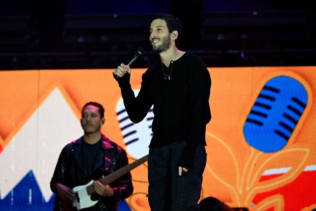 Colombian singer Sebastian Yatra performs on stage during the "Voces por la Vida" charity concert to support people affected by the 7.4-magnitude earthquake at the Vive Claro Distrito Cultural music venue in Bogota on August 23, 2026. (Photo by Raul ARBOLEDA / AFP)