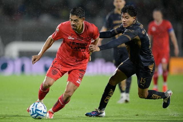 Necaxa's forward #30 Ricardo Monreal and Pumas' midfielder #15 Ulises Rivas fight for the ball during the Liga MX Apertura tournament football match between Pumas and Necaxa at the Olimpico Universitario stadium in Mexico City on August 23, 2026. (Photo by Alfredo ESTRELLA / AFP)