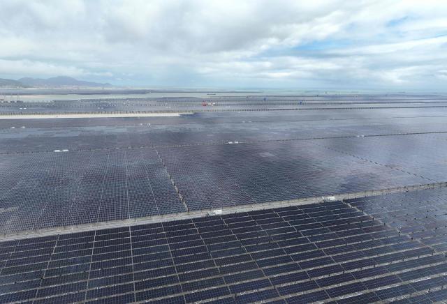This aerial photo shows a general view of solar panels at the construction site of the CNNC Tianwan Tidal Flat Photovoltaic in Lianyungang, China’s eastern Jiangsu province on August 23, 2026. (Photo by CN-STR / AFP) / China OUT