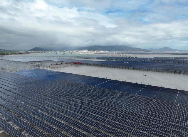 This aerial photo shows a general view of solar panels at the construction site of the CNNC Tianwan Tidal Flat Photovoltaic in Lianyungang, China’s eastern Jiangsu province on August 23, 2026. (Photo by CN-STR / AFP) / China OUT