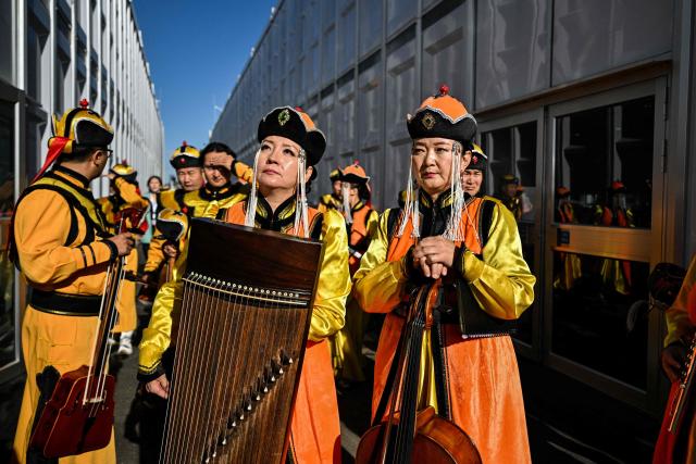 Musicians prepare to perform in the opening ceremony of the 17th Session of the Conference of the Parties (COP17) to the United Nations Convention to Combat Desertification (UNCCD) in Ulaanbaatar on August 24, 2026. (Photo by Hector RETAMAL / AFP)