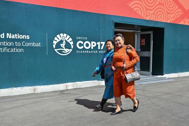 Visitors attend the 17th Session of the Conference of the Parties (COP17) of the United Nations Convention to Combat Desertification (UNCCD) at the venue in Ulaanbaatar on August 24, 2026. (Photo by Hector RETAMAL / AFP)