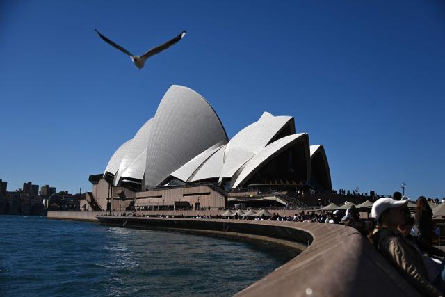 A seagull flies towards the Sydney Opera House in Sydney on August 24, 2026. (Photo by Saeed KHAN / AFP)
