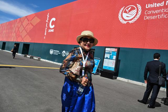 Visitors attend the 17th Session of the Conference of the Parties (COP17) of the United Nations Convention to Combat Desertification (UNCCD) at the venue in Ulaanbaatar on August 24, 2026. (Photo by Hector RETAMAL / AFP)