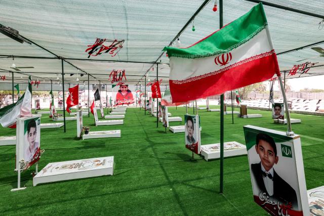(FILES) The graves of people and children killed during the strike on the Shajareh Tayyebeh primary school are pictured at a cemetery in Minab in Iran’s Hormozgan province on August 10, 2026. On February 28, the United States and Israel launched a massive offensive against Iran, igniting a war that swiftly engulfed the region and hit global energy markets. Six months on, the US and the Islamic republic remain locked in conflict, with no sign of an imminent resolution despite repeated rounds of negotiations. (Photo by ATTA KENARE / AFP) / 