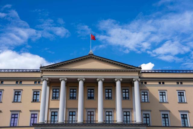 This picture taken on August 21, 2026 in Oslo shows the Royal Standard of Norway as it flutters atop the Palace. The Royal Standard depicts the Norwegian lion in gold bearing a silver axe on a red background and is hoisted whenever the King is in Norway or Norwegian territories. (Photo by Cornelius Poppe / NTB / AFP) / Norway OUT