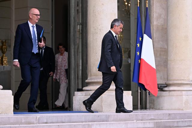 France's Economy and Finance Minister Roland Lescure (L) and France's Justice Minister Gerald Darmanin leave after the weekly cabinet meeting at the Elysee Palace in Paris on August 24, 2026. (Photo by LOU BENOIST / AFP)