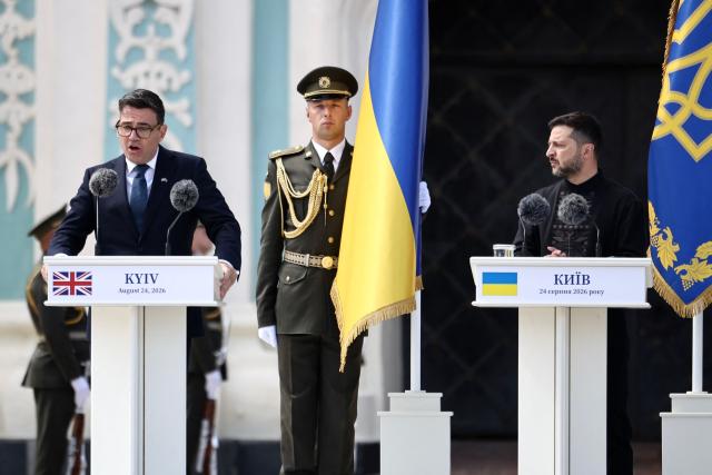 Britain's prime minister Andy Burnham (L) delivers a speech next to President Volodymyr Zelensky (C) during a commemorative ceremony marking Ukraine's 35th Independence Day outside St. Sofia cathedral in Kyiv on August 24, 2026. Ukraine hosts a meeting of its key European backers on August 24 to press for critical air-defence supplies and more pressure on Moscow, with Russian attacks killing more civilians than at any time since the first months of the invasion. The leaders of Luxembourg, Moldova, Estonia and EU Council President Antonio Costa are also in Kyiv for the talks hosted on Ukraine's Independence Day and which come amid the war's latest escalation. (Photo by Henry NICHOLLS / POOL / AFP)