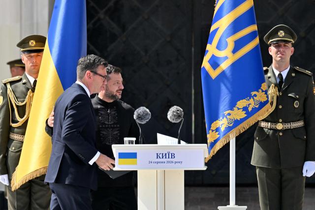 Britain's Prime Minister Andy Burnham (L) and  Ukraine's President Volodymyr Zelensky (R) leave after a commemorative ceremony marking Ukraine's 35th Independence Day outside St. Sofia cathedral in Kyiv on August 24, 2026. Ukraine hosts a meeting of its key European backers on August 24 to press for critical air-defence supplies and more pressure on Moscow, with Russian attacks killing more civilians than at any time since the first months of the invasion. The leaders of Luxembourg, Moldova, Estonia and EU Council President Antonio Costa are also in Kyiv for the talks hosted on Ukraine's Independence Day and which come amid the war's latest escalation. (Photo by Sergei SUPINSKY / AFP)
