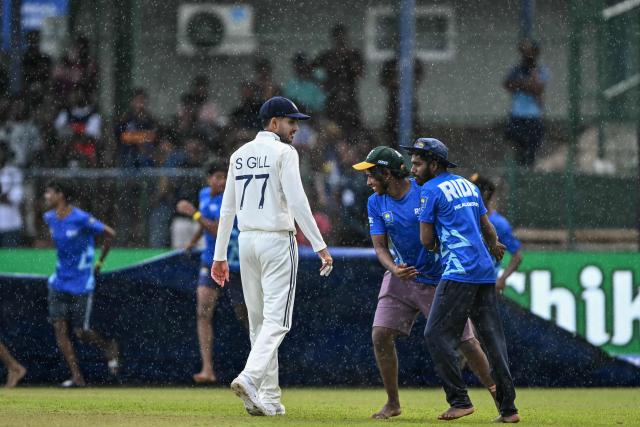 India's captain Shubman Gill (C) walks back to the pavilion after rain stops the play during the second day of the second Test cricket match between Sri Lanka and India at the Sinhalese Sports Club Ground in Colombo on August 24, 2026. (Photo by Ishara S. KODIKARA / AFP)