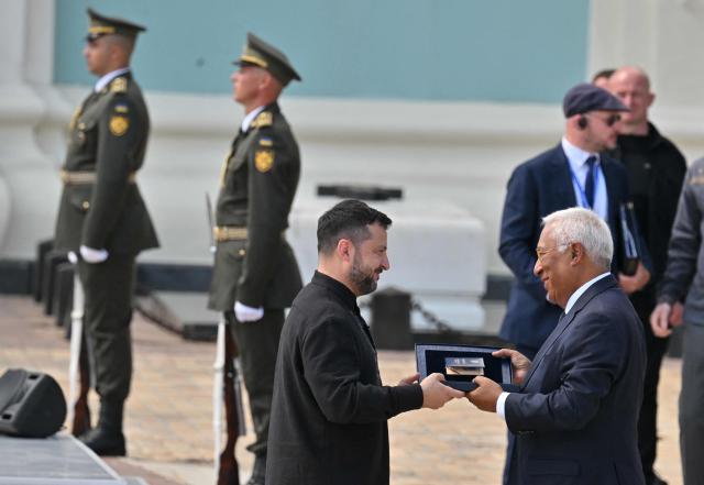 European Council President Antonio Costa (R) receives Ukrainian state award from Ukraine's President Volodymyr Zelensky during a commemorative ceremony marking Ukraine's 35th Independence Day outside St. Sofia cathedral in Kyiv on August 24, 2026. Ukraine hosts a meeting of its key European backers on August 24 to press for critical air-defence supplies and more pressure on Moscow, with Russian attacks killing more civilians than at any time since the first months of the invasion. The leaders of Luxembourg, Moldova, Estonia and EU Council President Antonio Costa are also in Kyiv for the talks hosted on Ukraine's Independence Day and which come amid the war's latest escalation. (Photo by Sergei SUPINSKY / AFP)