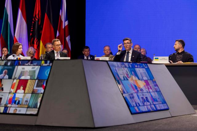 (From L) Moldova's President Maia Sandu, Finland's President Alexander Stubb, Britain's prime minister Andy Burnham and Ukraine's President Volodymyr Zelensky attend the Coalition of the Willing meeting, in Kyiv on August 24, 2026. The United Kingdom will keep providing defence aid to Ukraine despite Russia's threats, Prime Minister Andy Burnham said on August 24, 2026 on a visit to Kyiv where allies gathered to discuss support. Air defence supplies are due to be the main priority at the meeting of the Coalition of the Willing, jointly chaired by the leaders of France and Germany, who will participate remotely, and by Britain's Burnham. (Photo by Tetiana DZHAFAROVA / AFP)