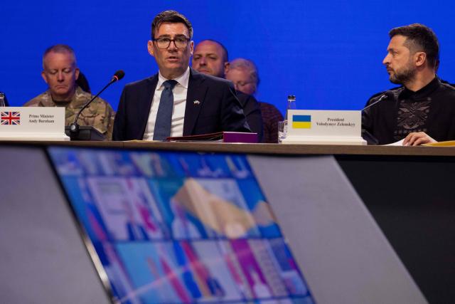 Britain's Prime Minister Andy Burnham (L) and Ukraine's President Volodymyr Zelensky (R) attend the Coalition of the Willing meeting, in Kyiv on August 24, 2026. The United Kingdom will keep providing defence aid to Ukraine despite Russia's threats, Prime Minister Andy Burnham said on August 24, 2026 on a visit to Kyiv where allies gathered to discuss support. Air defence supplies are due to be the main priority at the meeting of the Coalition of the Willing, jointly chaired by the leaders of France and Germany, who will participate remotely, and by Britain's Burnham. (Photo by Tetiana DZHAFAROVA / AFP)