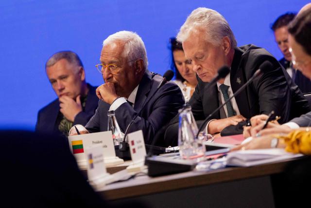 President of the European Council Antonio Costa (L) and Lithuania's President Gitanas Nauseda (R) react during the Coalition of the Willing meeting, in Kyiv on August 24, 2026. The United Kingdom will keep providing defence aid to Ukraine despite Russia's threats, Prime Minister Andy Burnham said on August 24, 2026 on a visit to Kyiv where allies gathered to discuss support. Air defence supplies are due to be the main priority at the meeting of the Coalition of the Willing, jointly chaired by the leaders of France and Germany, who will participate remotely, and by Britain's Burnham. (Photo by Tetiana DZHAFAROVA / AFP)