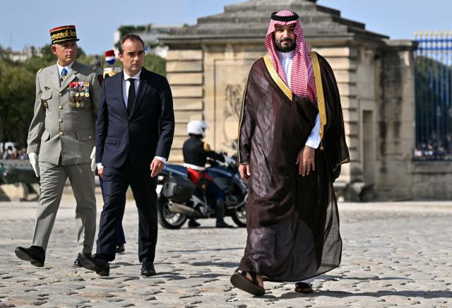 (From L) French Military Governor of Paris Loic Mizon and France's Prime Minister Sebastien Lecornu greet Saudi Arabia's Crown Prince Mohammed bin Salman during a welcome ceremony as part of his two-day official visit to France, at the Hotel des Invalides in Paris on August 24, 2026. (Photo by Julie SEBADELHA / AFP)