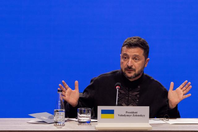 Ukraine's President Volodymyr Zelensky gestures as he speaks during the Coalition of the Willing meeting, in Kyiv on August 24, 2026. The United Kingdom will keep providing defence aid to Ukraine despite Russia's threats, Prime Minister Andy Burnham said on August 24, 2026 on a visit to Kyiv where allies gathered to discuss support. Air defence supplies are due to be the main priority at the meeting of the Coalition of the Willing, jointly chaired by the leaders of France and Germany, who will participate remotely, and by Britain's Burnham. (Photo by Tetiana DZHAFAROVA / AFP)