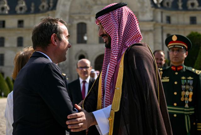 France's Prime Minister Sebastien Lecornu (L) speaks with Saudi Arabia's Crown Prince Mohammed bin Salman during a welcome ceremony as part of his two-day official visit to France, at the Hotel des Invalides in Paris on August 24, 2026. (Photo by Julie SEBADELHA / POOL / AFP)