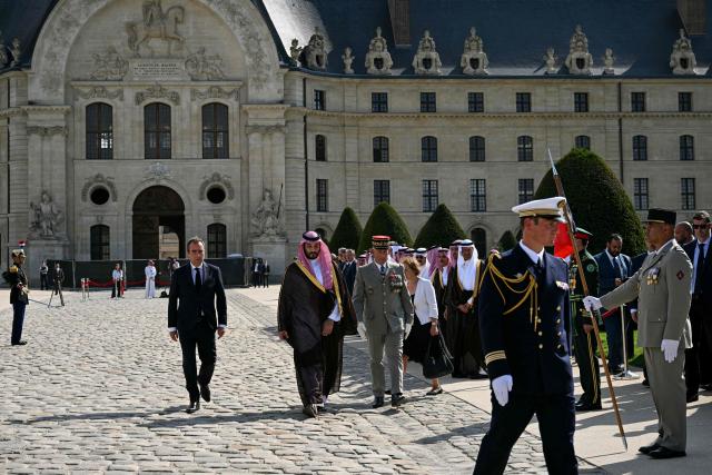 (From L) France's Prime Minister Sebastien Lecornu, Saudi Arabia's Crown Prince Mohammed bin Salman and French Military Governor of Paris Loic Mizon walk alongside each other during a welcome ceremony as part of the Crown Prince's two-day official visit to France, at the Hotel des Invalides in Paris on August 24, 2026. (Photo by Julie SEBADELHA / POOL / AFP)