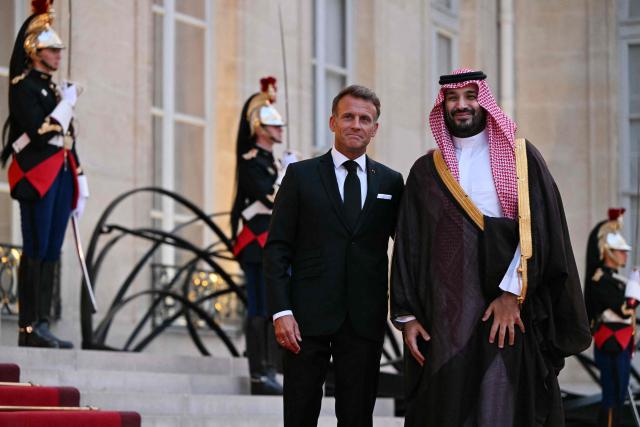 France's President Emmanuel Macron (L) welcomes Saudi Arabia's Crown Prince Mohammed bin Salman as he arrives for a State diner in his honour at the Elysee Palace in Paris on August 24, 2026. (Photo by LOU BENOIST / AFP)
