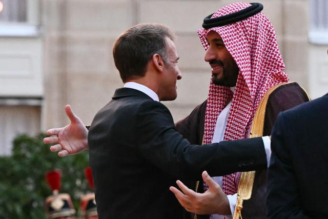France's President Emmanuel Macron (L) welcomes Saudi Arabia's Crown Prince Mohammed bin Salman as he arrives for a State diner in his honour at the Elysee Palace in Paris on August 24, 2026. (Photo by LOU BENOIST / AFP)