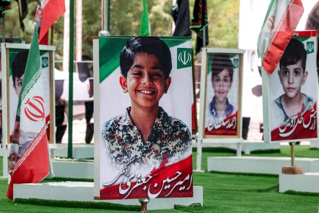 The graves of people and children killed during the strike on the Shajareh Tayebeh primary school are pictured at a cemetery in Minab in Irans Hormozgan province on August 10, 2026. Six months on, a team of AFP journalists obtained rare access to the school which has remained largely in ruins, its collapsed walls and twisted steel now surrounded by portraits of the children killed as Iranian flags flutter above the rubble. Iran says the attack on the school involved two separate US Tomahawk missiles but neither the United States nor Israel has officially claimed responsibility for the strike. (Photo by ATTA KENARE / AFP) / 