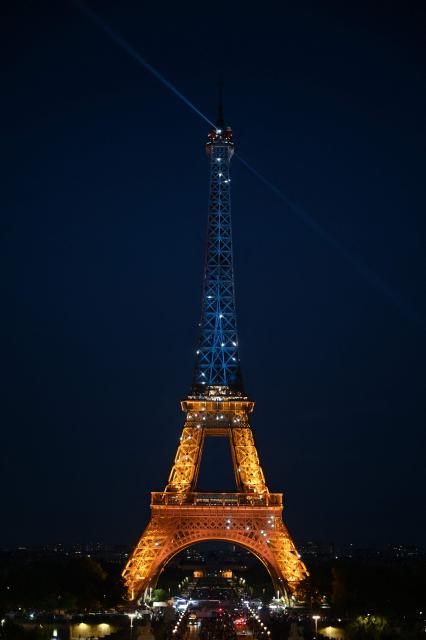 This photograph shows the Eiffel Tower illuminated in the colours of the Ukrainian flag to commemorate the 35th anniversary of Ukrainian independence, in Paris, on August 24, 2026. (Photo by Christophe DELATTRE / AFP)