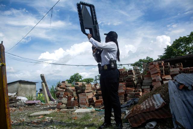 A police officer holds an anti-drone device while providing security during a visit by Colombia's President Abelardo de la Espriella to an area damaged by a 7.4-magnitude earthquake in Buenaventura, Valle del Cauca department, Colombia, on August 24, 2026. (Photo by Cesar Queiroz / AFP)