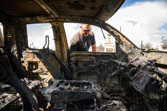 A resident checks what's left of his work truck burned by the Hawk Fire in Reno, Nevada on August 24, 2026. Tens of thousands of people looked set to spend another night away from home on August 24 as a wind-driven fire bore down on the western US city of Reno. Schools were shuttered as smoke swathed the city in Nevada, near the California border, home to around 280,000 people.
Around 24,000 were still under evacuation orders on Monday, officials said, down from over 40,000 at its peak. (Photo by Josh Edelson / AFP)
