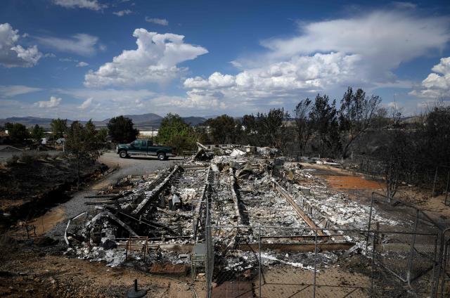 A burned home smolders after it was destroyed by the Hawk fire in Reno, Nevada on August 24, 2026. Tens of thousands of people looked set to spend another night away from home on August 24 as a wind-driven fire bore down on the western US city of Reno. Schools were shuttered as smoke swathed the city in Nevada, near the California border, home to around 280,000 people.
Around 24,000 were still under evacuation orders on Monday, officials said, down from over 40,000 at its peak. (Photo by Josh Edelson / AFP)