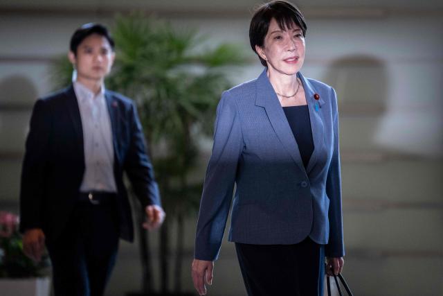 Japan's Prime Minister Sanae Takaichi (R) arrives at the Prime Minister's office in Tokyo on August 25, 2026. (Photo by Yuichi YAMAZAKI / AFP)