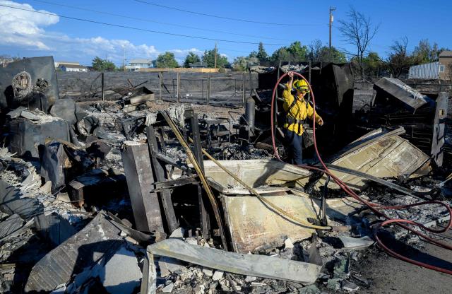 A firefighter works on the remains of a home burned by the Hawk Fire in Reno, Nevada on August 24, 2026. Tens of thousands of people looked set to spend another night away from home on August 24 as a wind-driven fire bore down on the western US city of Reno. Schools were shuttered as smoke swathed the city in Nevada, near the California border, home to around 280,000 people.
Around 24,000 were still under evacuation orders on Monday, officials said, down from over 40,000 at its peak. (Photo by Josh Edelson / AFP)