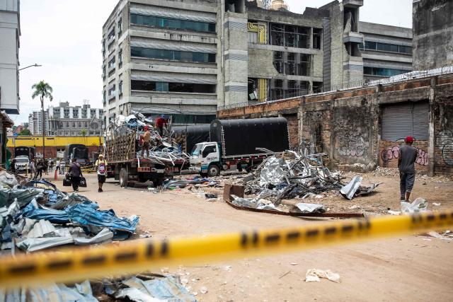 Workers clear the rubble from a collapsed building 14 days after the 7.4-magnitude earthquake in Pereira, Colombia on August 24, 2026. The powerful earthquake that killed hundreds of people in western Colombia on August 10, 2026, caused $9.57 billion in economic losses, President Abelardo de la Espriella said on August 18, issuing a preliminary estimate. The death toll stands at 289, with a further 4,187 injured and 143 missing. (Photo by ESTEBAN VEGA LA-ROTTA / AFP)