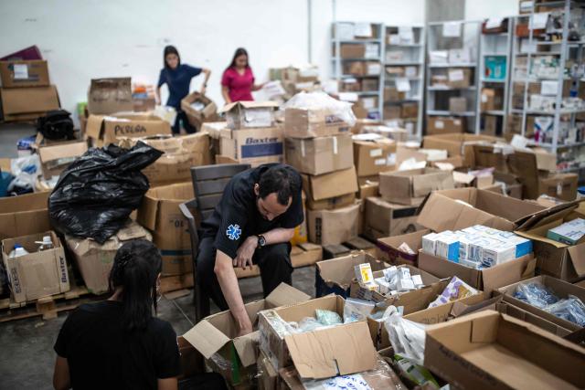 Health workers organise the medicine dispensary 14 days after the 7.4-magnitude earthquake in Pereira, Colombia on August 24, 2026. The powerful earthquake that killed hundreds of people in western Colombia on August 10, 2026, caused $9.57 billion in economic losses, President Abelardo de la Espriella said on August 18, issuing a preliminary estimate. The death toll stands at 289, with a further 4,187 injured and 143 missing. (Photo by ESTEBAN VEGA LA-ROTTA / AFP)