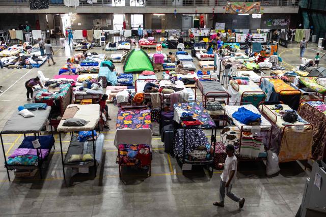 People take temporary shelter at the Coliseo Menor 14 days after the 7.4-magnitude earthquake in Pereira, Colombia on August 24, 2026. The powerful earthquake that killed hundreds of people in western Colombia on August 10, 2026, caused $9.57 billion in economic losses, President Abelardo de la Espriella said on August 18, issuing a preliminary estimate. The death toll stands at 289, with a further 4,187 injured and 143 missing. (Photo by ESTEBAN VEGA LA-ROTTA / AFP)